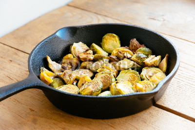 Roasted Brussels sprouts and chestnuts with a balsamic vinegar sauce in a cast iron skillet