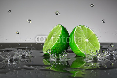 Lime with water drops on grey background