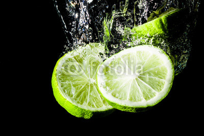 Lemon slice splashing into water.