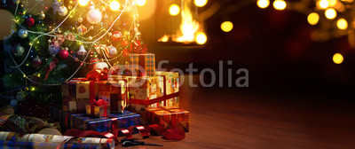 Christmas tree and holidays present on fireplace background