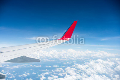 airplane wing above the clouds