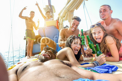 Happy friends taking selfie photo in boat party toasting beer