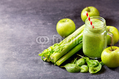 glass jar of green juice smoothie with spinach, apple and celery
