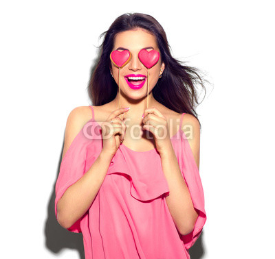 Valentines Day. Beauty joyful young fashion model girl with Valentine Heart shaped cookies in her hands