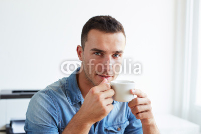 Man in the office with coffee cup