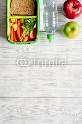 kid menu lunchbox for school top view on wooden background
