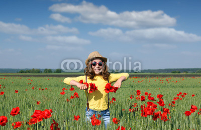 happy little girl on poppies flower field
