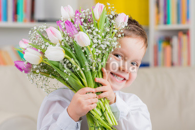 kleiner junge mit tulpenstrauß zum muttertag