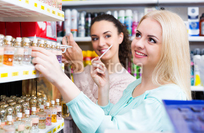 Female friends buying perfume