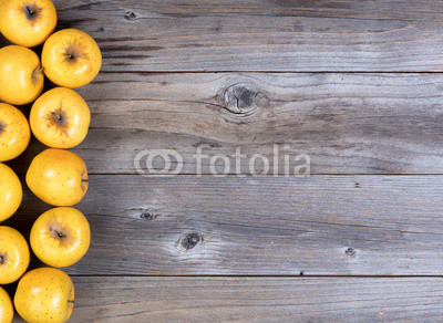 Freshly harvested golden apples on rustic wooden boards