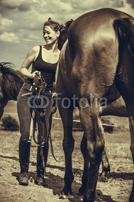 Jockey woman taking care of horse