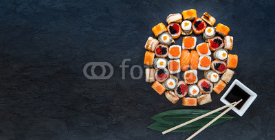 Sushi net on a black surface. Flat lay