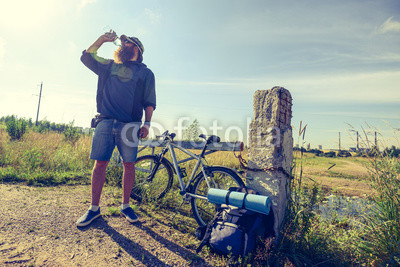 man drinks water on a halt