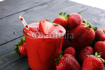 Fresh strawberry smoothie on wooden table