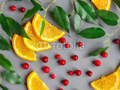Fruit background design of citrus slices and cranberries. Fruit pattern.