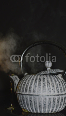the kettle on the stove on a black background