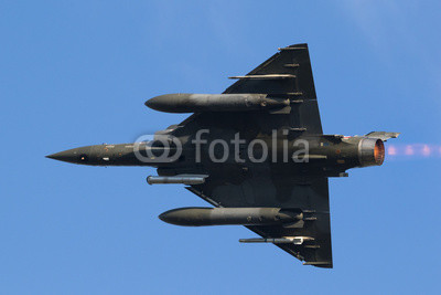 Fast green air force fighter jet flyby