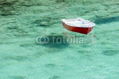 Barca floating in transparent water