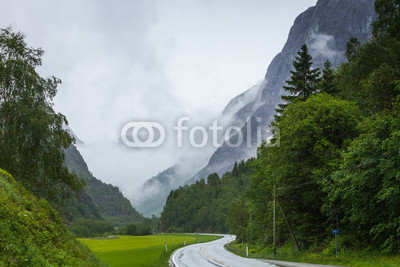 Foggy landscape with road in norwegian mountains