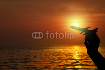 Silhouette of hand holding airplane , Travel concept