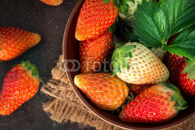  Top view of Red Strawberries and leaf with black stone background