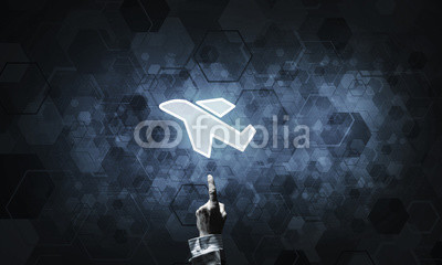 Airplane glowing icon touched with finger as online booking conc