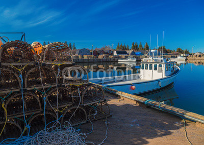 Commercial fishing boats at a wharf in rural Prince Edward Island, Canada.
