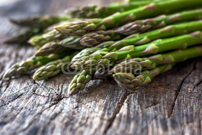 Fresh organic asparagus on rustic background