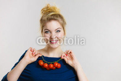 Woman holding fresh cherry tomatoes