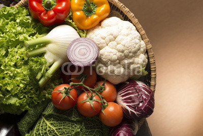 still life with vegetables isolated on brown background