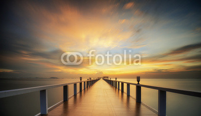 Wooded bridge in the port between sunrise.