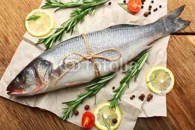 Fresh raw fish and food ingredients on table