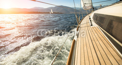 Yacht sailing towards the sunset. Sailing. Luxury yachts.