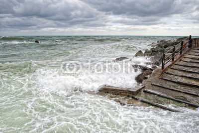 sea in tempest on rocks of italian village