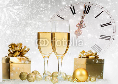 Champagne and gift box against fireworks and holiday lights