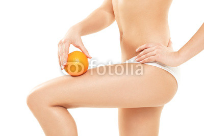 Young woman in underwear holding an orange showing absence of ce