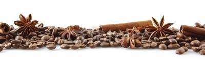 Scattered coffee beans in line on white