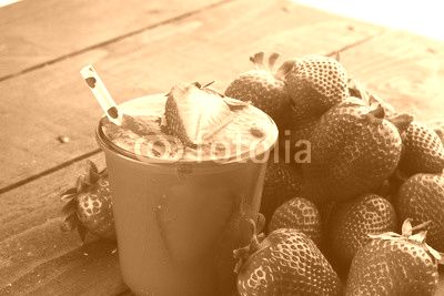 Fresh strawberry smoothie on wooden table