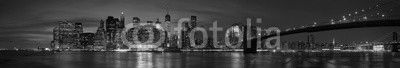 New York city with Brooklyn Bridge, iconic skyline panorama at night in black and white