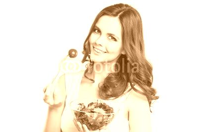 Close-up of pretty girl eating fresh vegetable salad.