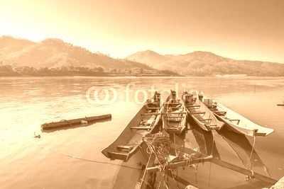 Traditional old wooden fishing boat floating on Mekong river in North Thailand, outdoor day light