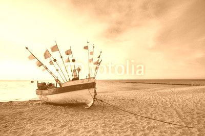 Vintage retro stylized photo of fishing boats on the sea beach