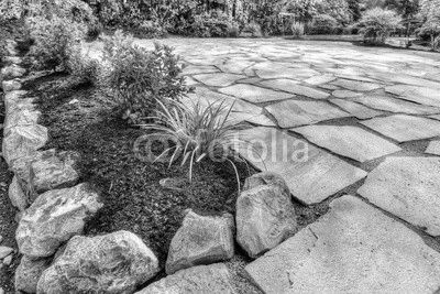 Completed flower beds around new stone patio with plants in place