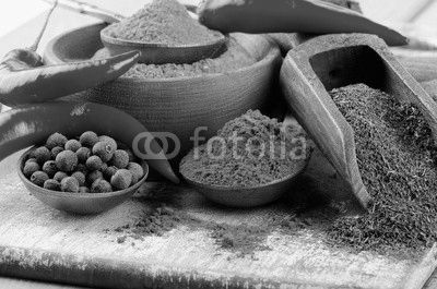 spices on spoons on  wooden background