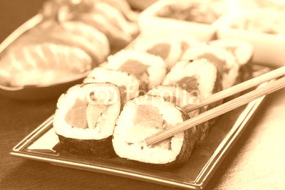 sushi pieces with chopsticks