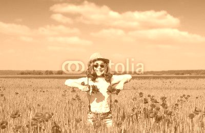happy little girl on poppies flower field