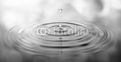 Wassertropfen und Wellen mit grüner Spiegelung