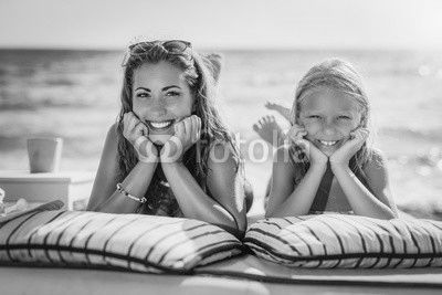 Mom And Daughter Posing At The Beach