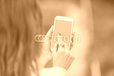 Girl using cellphone outdoors.
