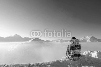 Man at mountains in clouds